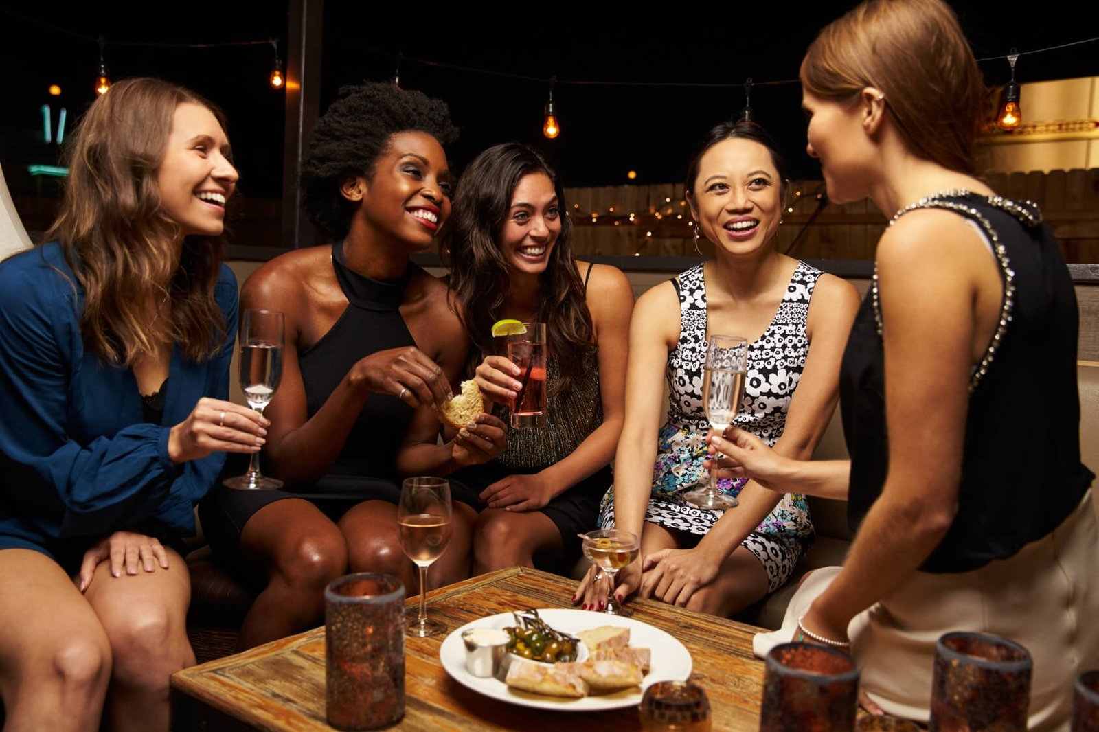 Group Of Female Friends Enjoying Night Out At Rooftop Bar - hilton-t5.co.uk - hilton-t5.co.uk christmas party at Hilton Heathrow