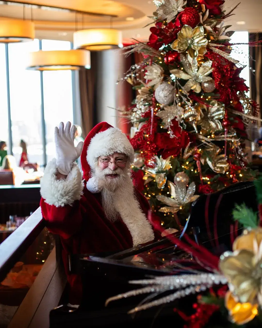 Santa sat in front of Christmas tree