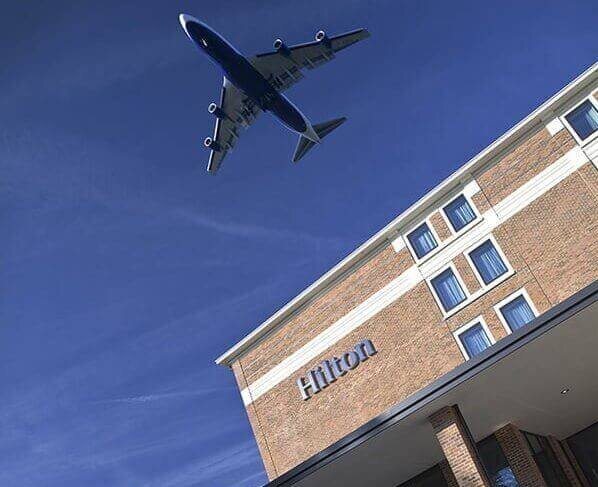 Plane flying over Hilton T5