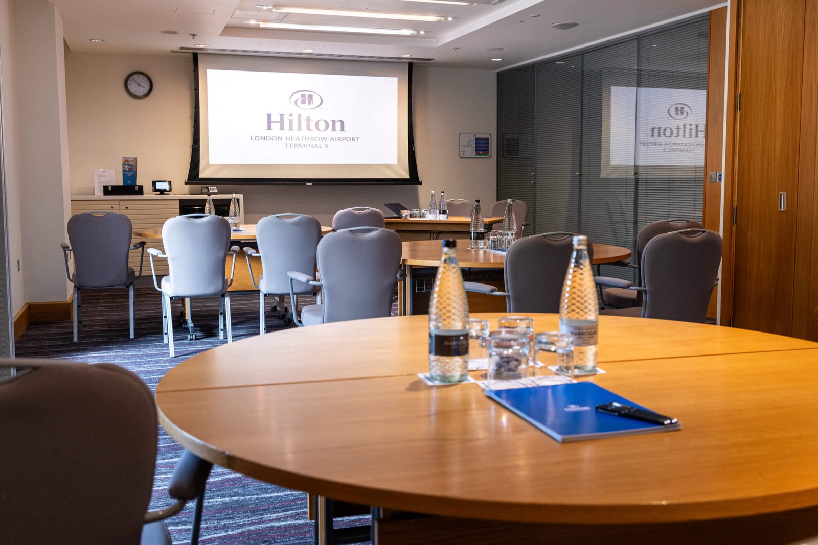 Saffron meeting room, set up with water and a projector